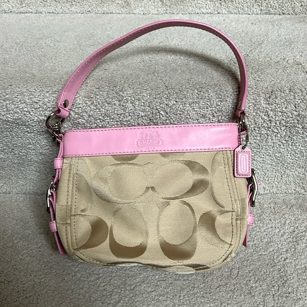 Coach small purse. Tan color with pink strap and pink lining.